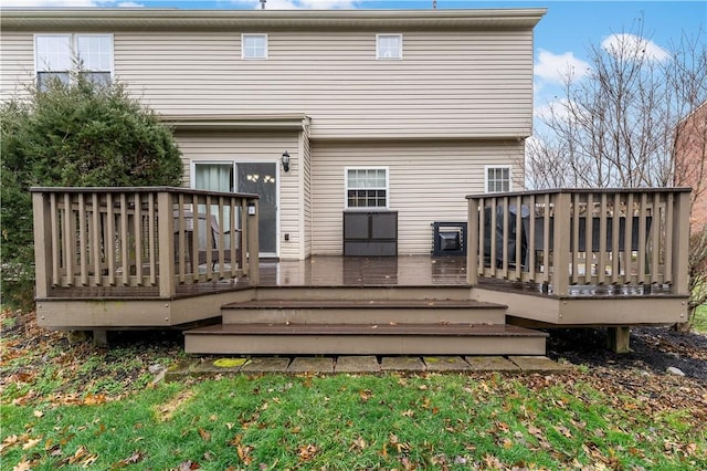 rear view of property featuring a deck