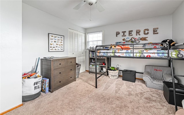 bedroom featuring ceiling fan, light carpet, and a closet