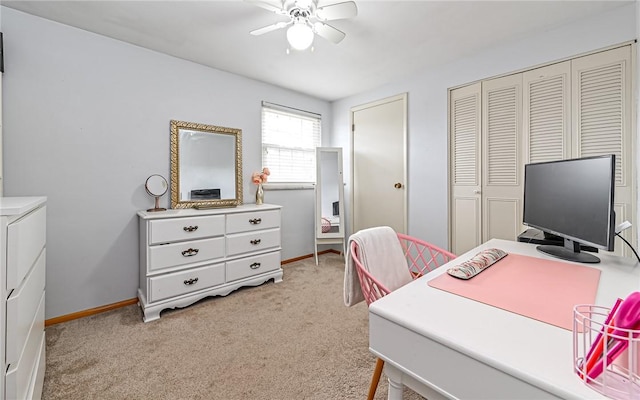 carpeted office space with ceiling fan