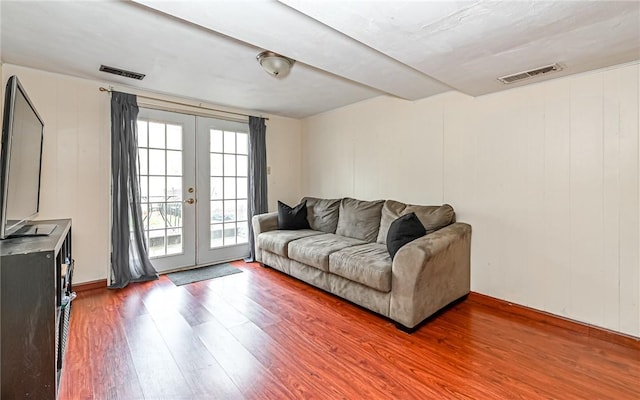 living room featuring french doors and hardwood / wood-style flooring