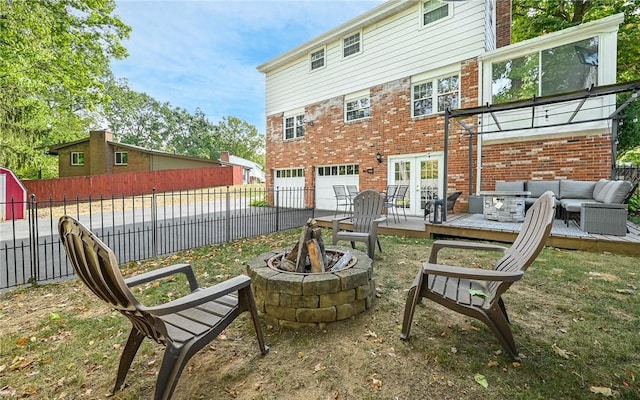 exterior space featuring a deck and an outdoor living space with a fire pit