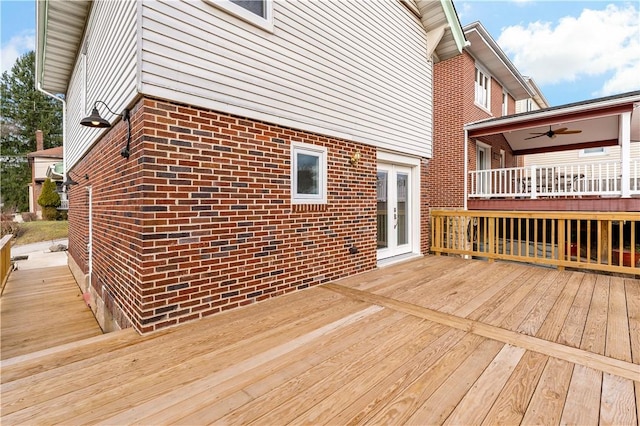 wooden deck featuring ceiling fan and french doors