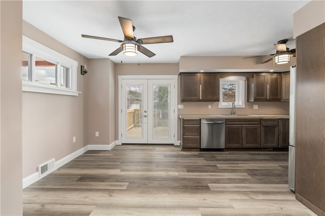 kitchen with dishwasher, french doors, a wealth of natural light, and sink