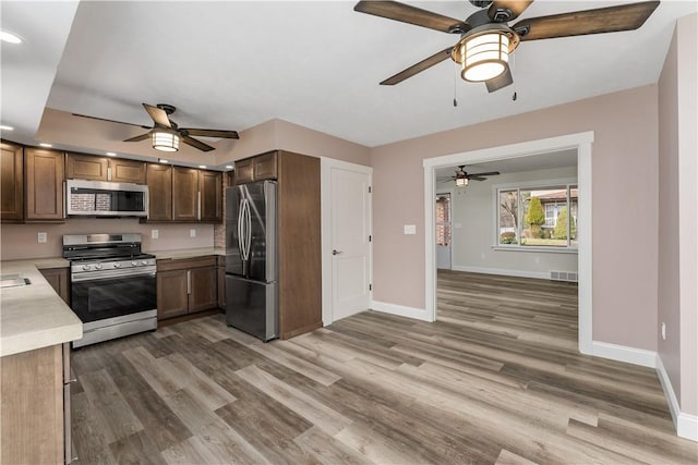 kitchen featuring hardwood / wood-style flooring and stainless steel appliances