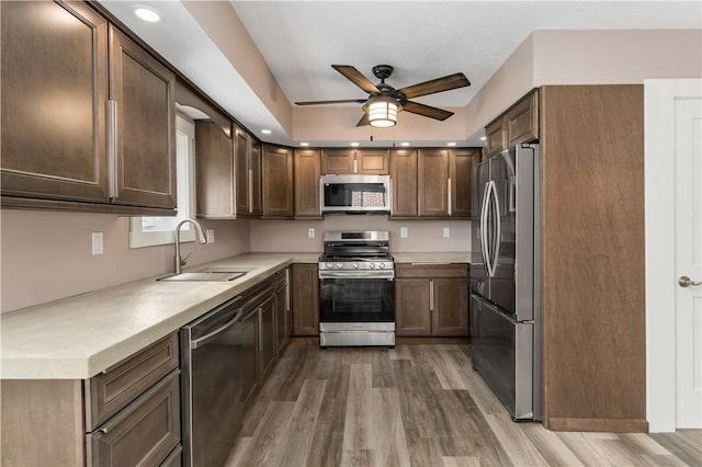 kitchen with hardwood / wood-style flooring, sink, ceiling fan, and appliances with stainless steel finishes