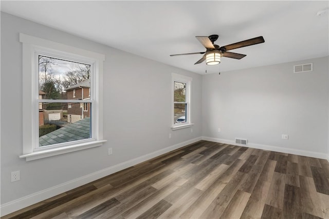 spare room featuring ceiling fan and dark hardwood / wood-style floors