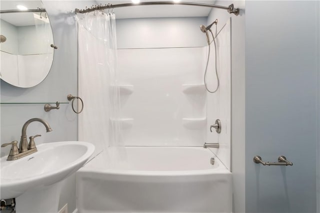 bathroom featuring sink and shower / tub combo with curtain