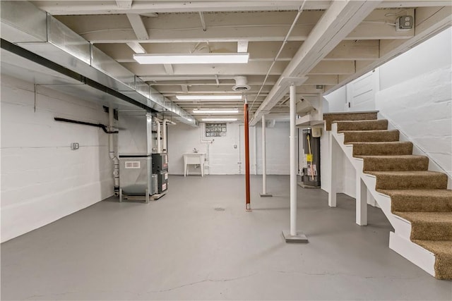 basement featuring heating unit and water heater