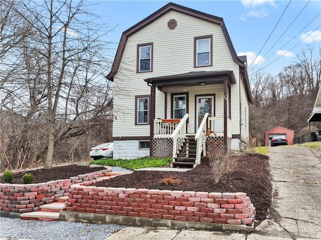 view of front property with covered porch and an outdoor structure