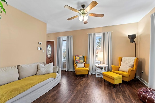 living room with ceiling fan and dark hardwood / wood-style flooring