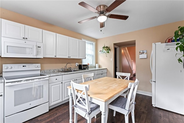 kitchen featuring white cabinets, dark hardwood / wood-style flooring, white appliances, and sink