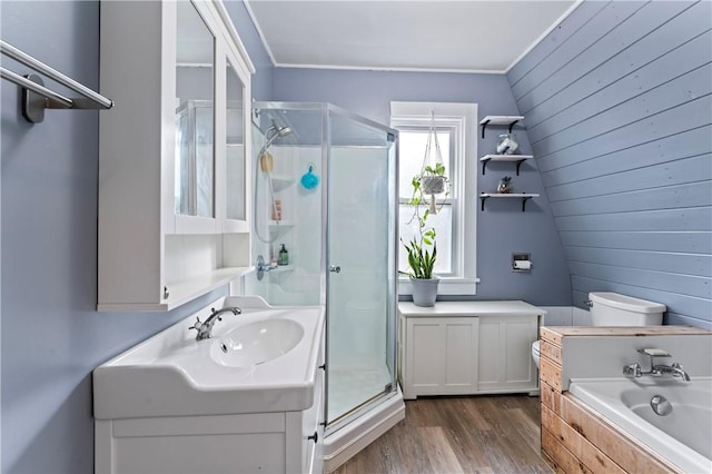 full bathroom with hardwood / wood-style flooring, vanity, shower with separate bathtub, and wooden walls