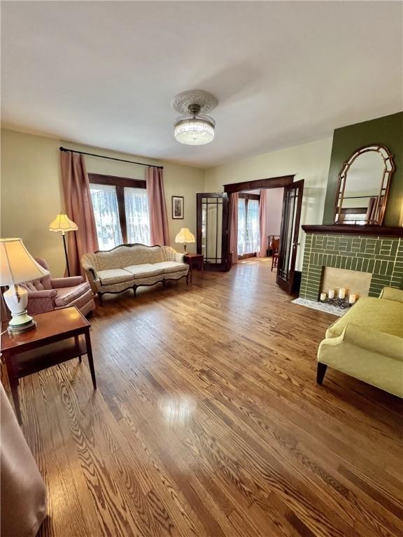 sitting room featuring a fireplace and hardwood / wood-style floors