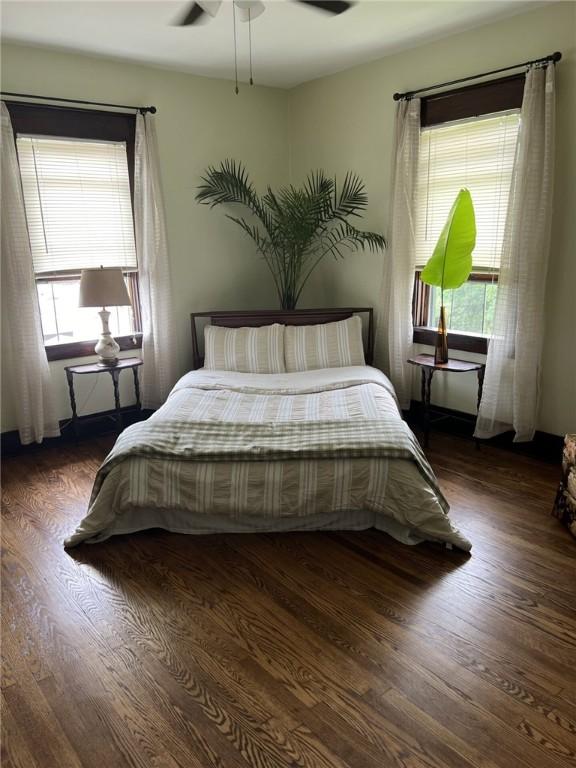 bedroom featuring ceiling fan and dark hardwood / wood-style flooring