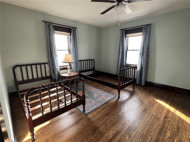 bedroom with ceiling fan and wood-type flooring