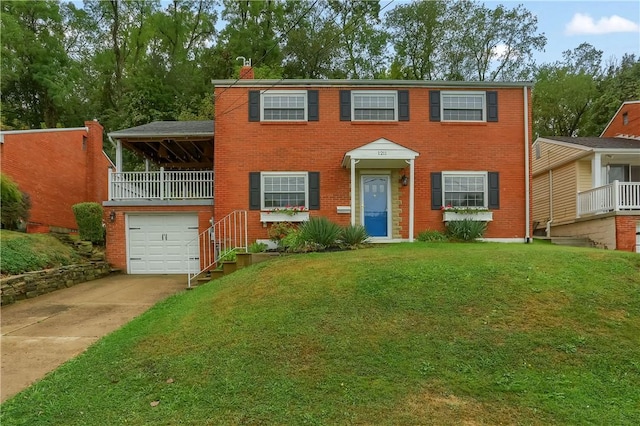 view of front of home with a garage and a front lawn