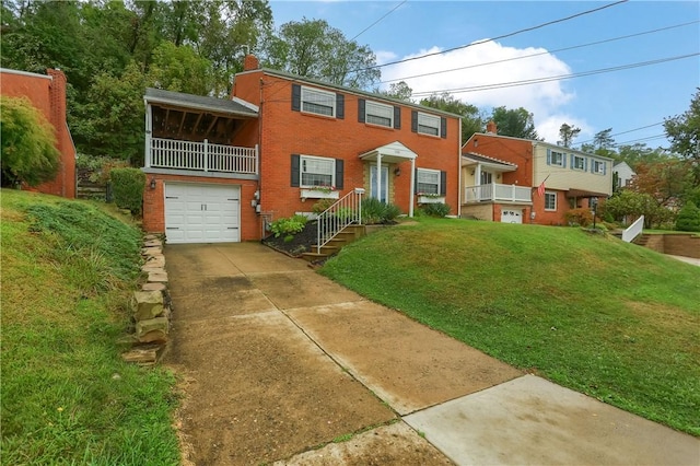 view of front of property featuring a garage, a balcony, and a front lawn