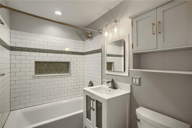 full bathroom with vanity, toilet, and tiled shower / bath combo