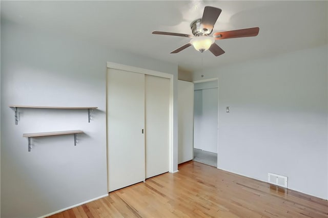 unfurnished bedroom featuring ceiling fan and light hardwood / wood-style floors