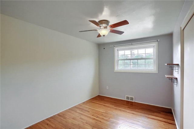 unfurnished room featuring ceiling fan and light wood-type flooring