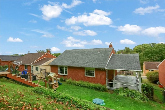 rear view of property with a yard