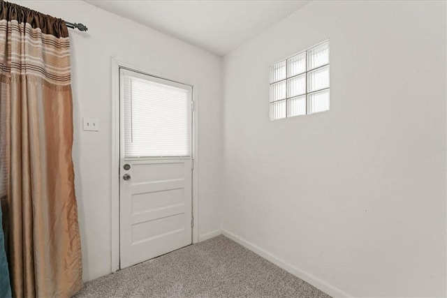 doorway featuring carpet flooring