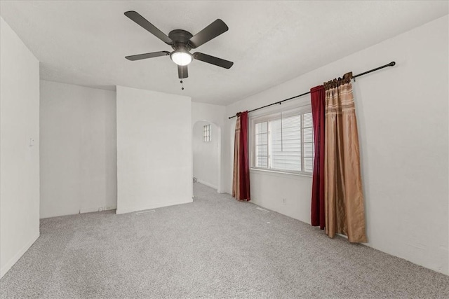 spare room featuring ceiling fan and light carpet