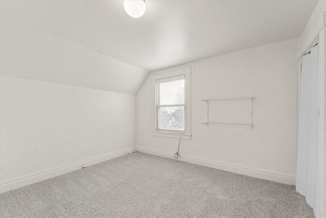 bonus room with carpet floors and lofted ceiling