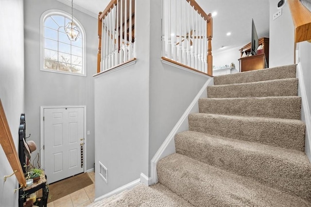 foyer entrance featuring light tile patterned flooring and an inviting chandelier