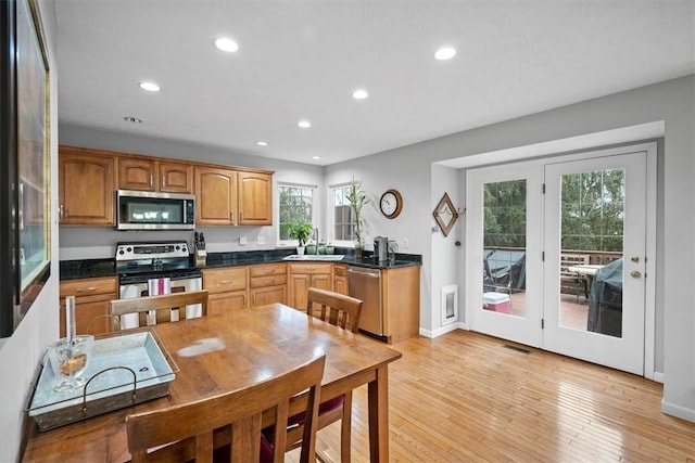 kitchen with sink, light wood-type flooring, and appliances with stainless steel finishes