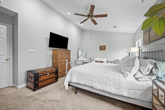 bedroom featuring ceiling fan, lofted ceiling, and light carpet