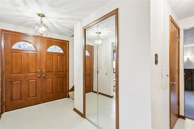 foyer featuring a chandelier