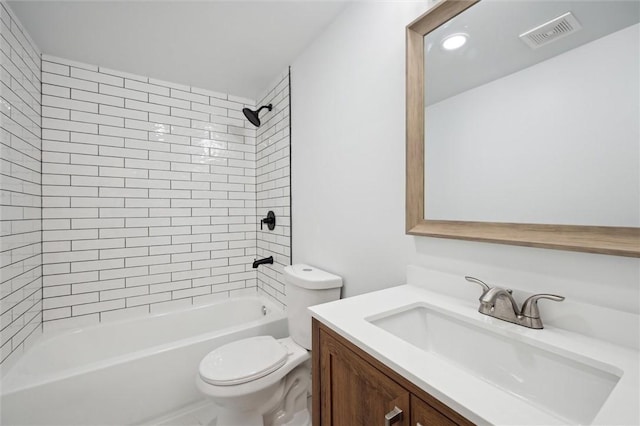 full bathroom with vanity, tiled shower / bath combo, and toilet