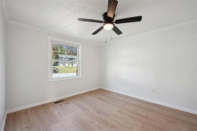 spare room featuring crown molding, ceiling fan, and light wood-type flooring