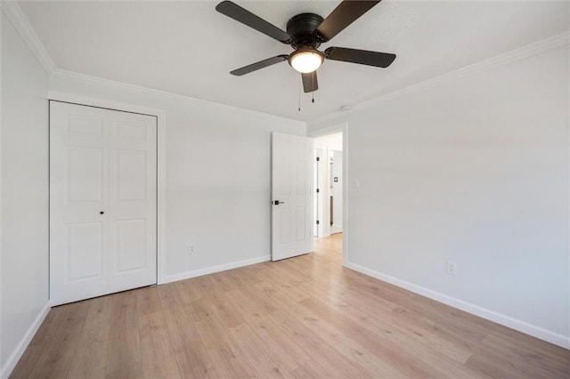 unfurnished bedroom featuring a closet, ceiling fan, crown molding, and light hardwood / wood-style floors