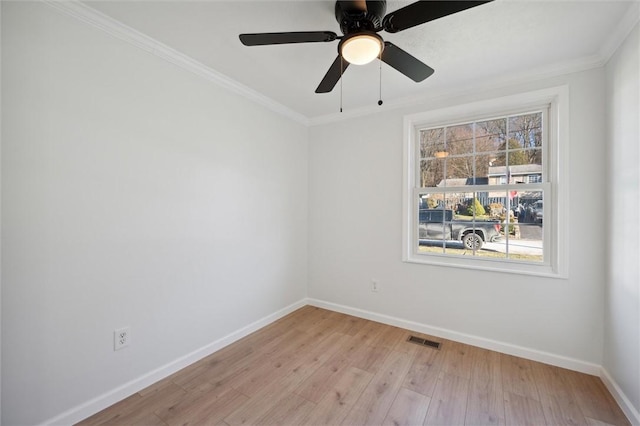 spare room featuring ceiling fan, light wood-type flooring, and crown molding