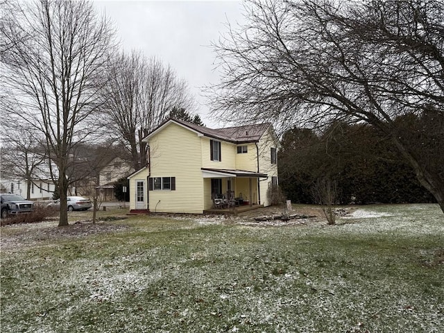 view of home's exterior featuring covered porch and a yard