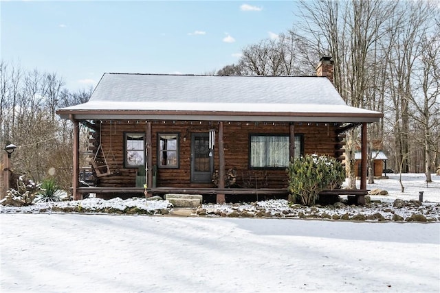 log-style house featuring covered porch