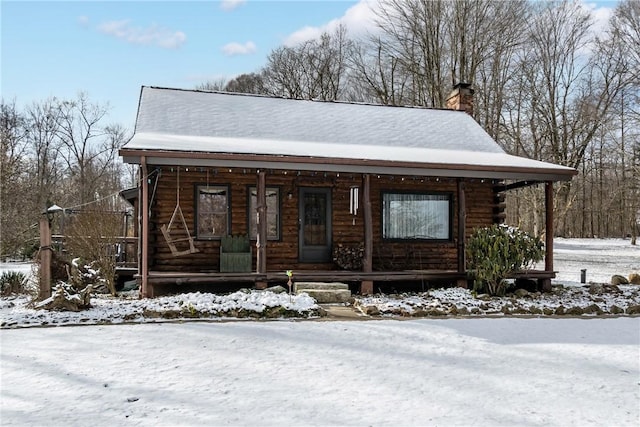 log-style house featuring a porch