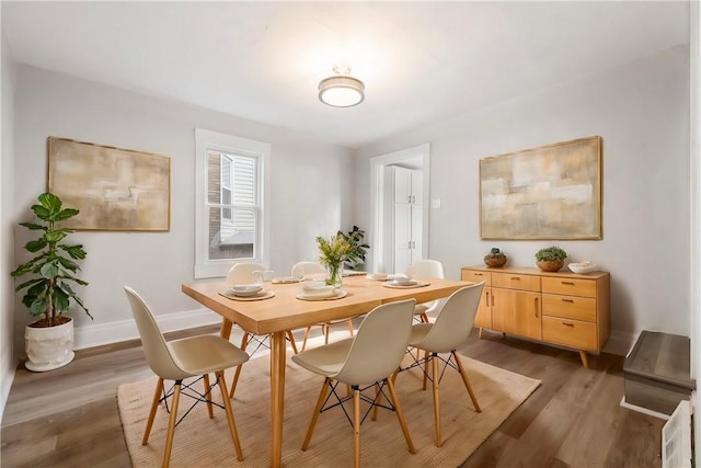 dining space featuring dark wood-type flooring