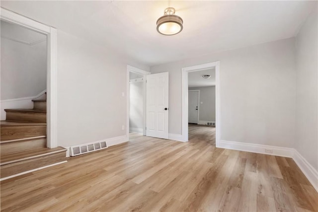 spare room with light hardwood / wood-style flooring