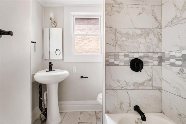 bathroom featuring toilet and tiled shower / bath