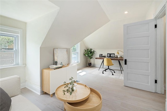 office space featuring light hardwood / wood-style flooring and lofted ceiling