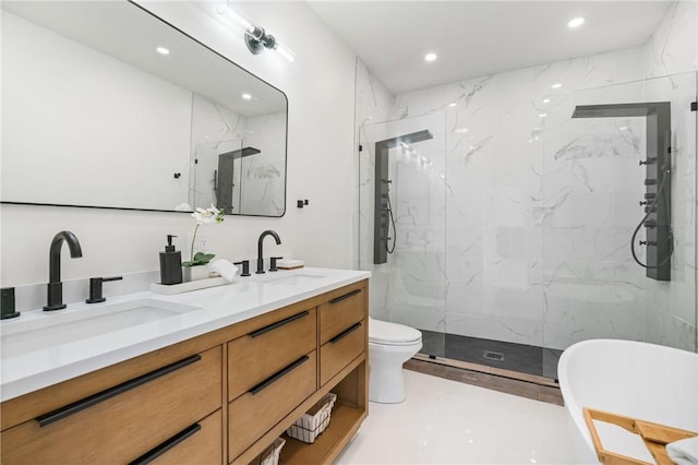 bathroom featuring a tile shower, vanity, and toilet