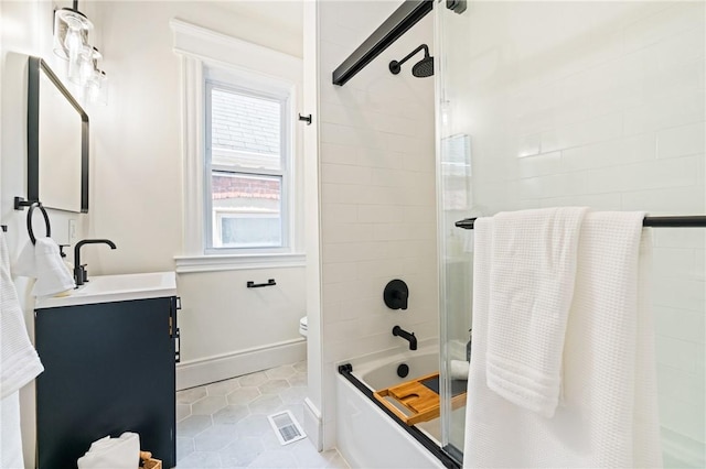 full bathroom featuring tile patterned floors, vanity, bath / shower combo with glass door, and a wealth of natural light