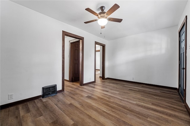 unfurnished bedroom with ceiling fan and dark hardwood / wood-style floors