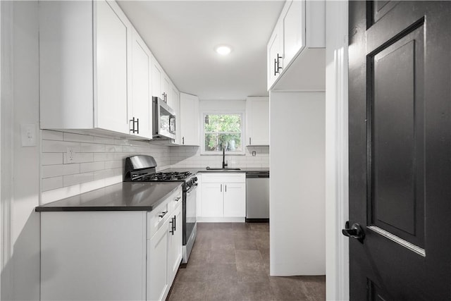 kitchen featuring white cabinets, decorative backsplash, sink, and appliances with stainless steel finishes