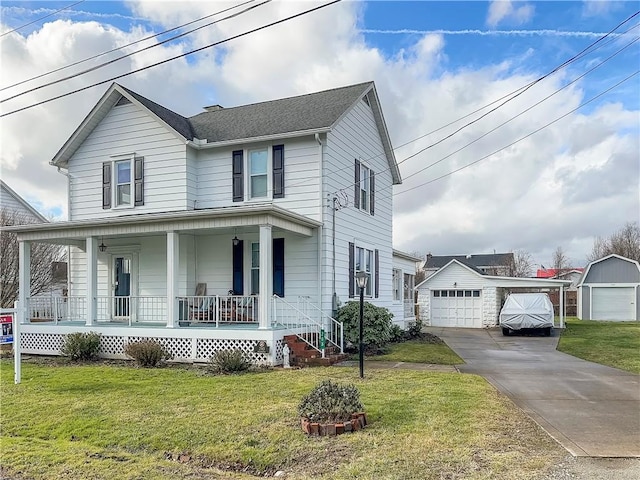 view of front of property with a front yard, a garage, an outdoor structure, and covered porch