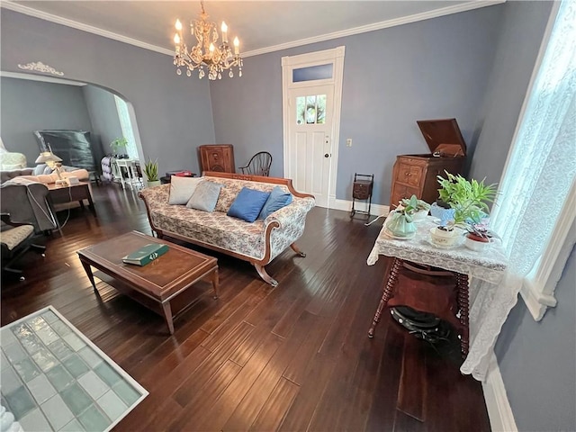 living room featuring dark hardwood / wood-style flooring, a chandelier, and ornamental molding