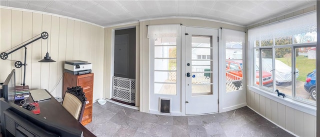 interior space featuring a wealth of natural light, french doors, wooden walls, and ornamental molding